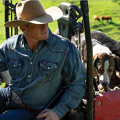 Man in cowboy hat wearing Wrangler denim shirt